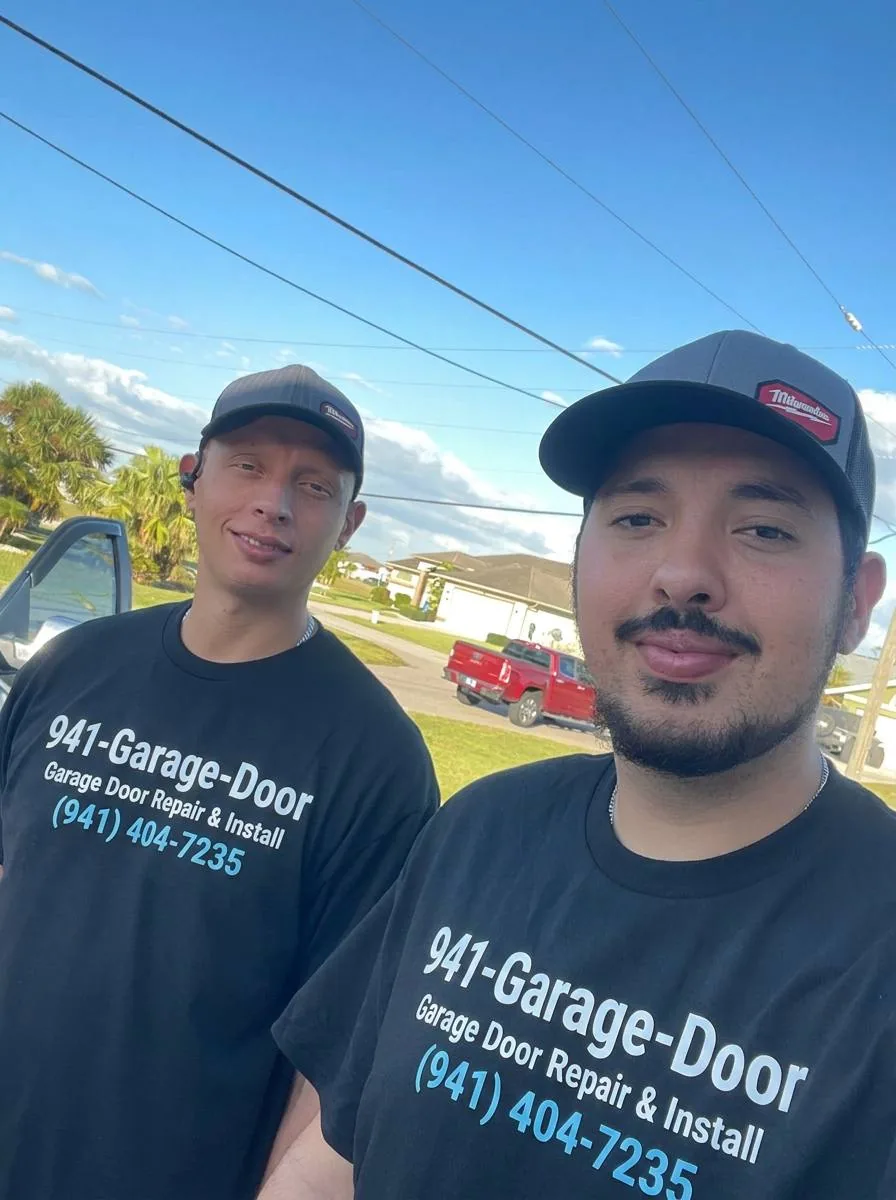 Two uniformed 941-Garage-Door technicians on a residential service call in Port Charlotte